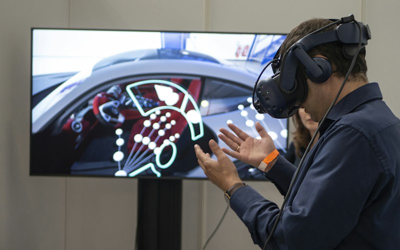 Engineer using a VR headset to inspect a simulated vehicle model